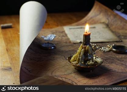 candle lie on old ancient map