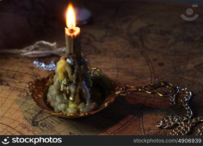 candle lie on old ancient map