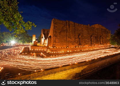 candle light trail of Buddhism Ceremony at temple ruin on Asalha Puja day