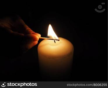candle lit match on a black background