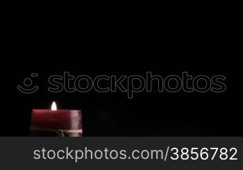 Candle on a black background.
