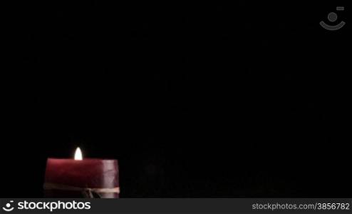 Candle on a black background.
