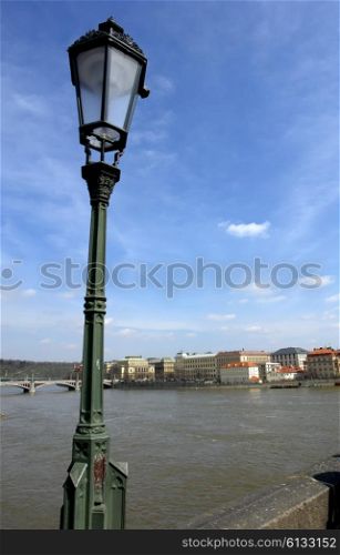 candle over river vlatva in prague town
