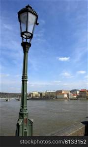 candle over river vlatva in prague town