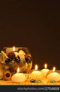 Candles and a set of the decorative stones, the flavored slices of a tree. Spa theme