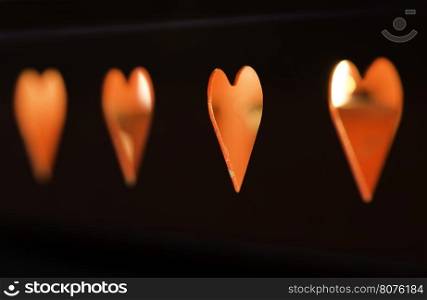 Candles and red heart shapes.