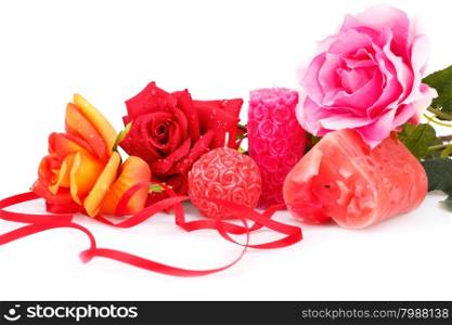 Candles and roses isolated on white background.