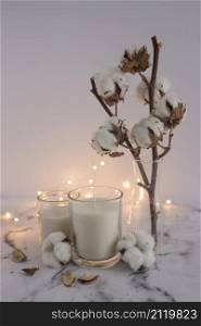 candles decorated with cotton twig lighting equipments marble surface