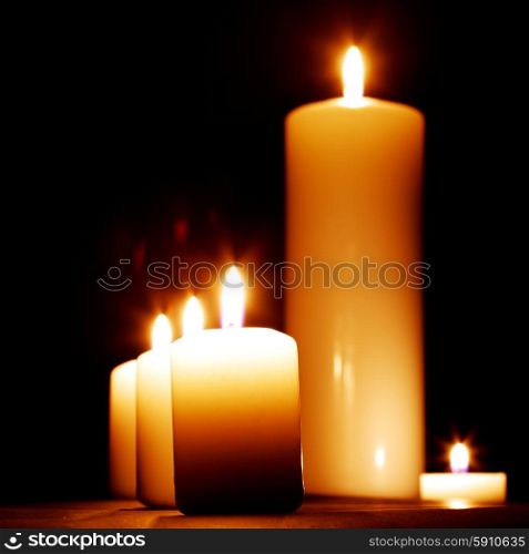 Candles. Group of burning candles isolated on black background