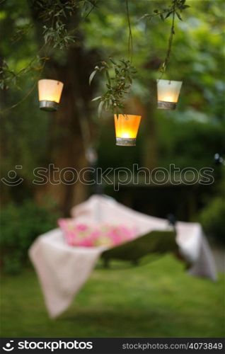 Candles hanging from branches