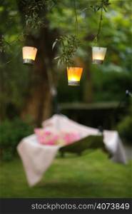 Candles hanging from branches