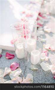 candles in glass cups at a wedding. White candles at a wedding ceremony. candles in glass cups at the wedding