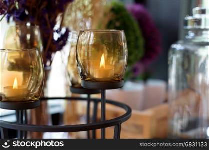 candles lit in brown glass, interior decoration