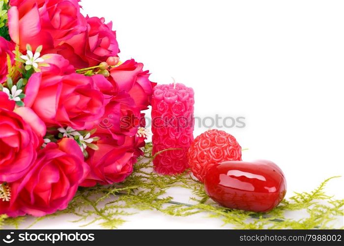 Candles, roses and glass heart isolated on white background.