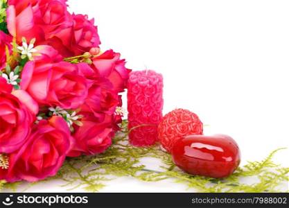 Candles, roses and glass heart isolated on white background.