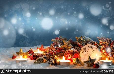 candles with christmas decoration bokah or falling snow on background. candles with christmas decoration