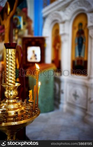 Candlestick with burning candles in a church