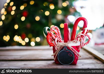 Candy canes in a basket on christmas background