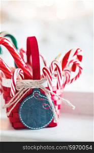 Candy canes in a basket on christmas background