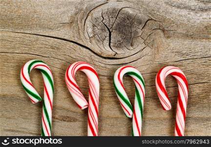 Candy canes on rustic wooden board. Layout in horizontal format.