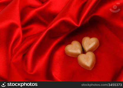 candy hearts on red satin background