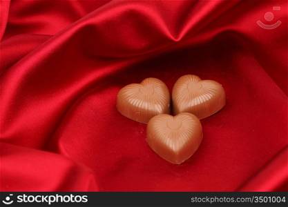 candy hearts on red satin background