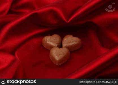 candy hearts on red satin background