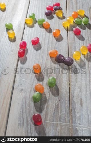 Candy scattered on the wooden table