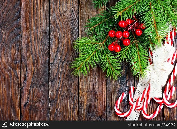 candycanes and christmas tree on the wooden table
