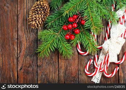 candycanes and christmas tree on the wooden table