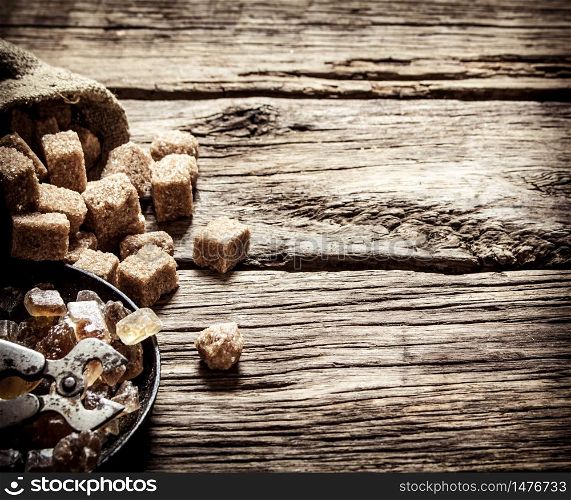 Cane sugar. On a wooden background. Free text space. Cane sugar. On wooden background.
