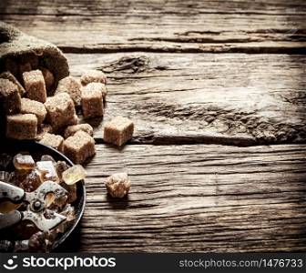 Cane sugar. On a wooden background. Free text space. Cane sugar. On wooden background.