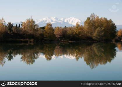 Caniou and autumnal colour reflected in a still lake