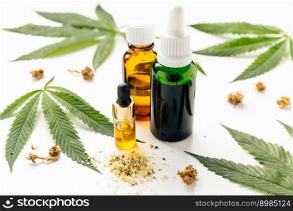 Cannabis oil, hemp leaves, dry flowers on white background. Natural cosmetics. Omega fats. Increasingly legal and medical use of marijuana. Cannabis oil, hemp leaves, dry flowers on white