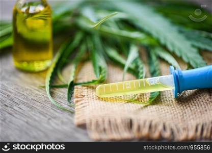 Cannabis oil on bottle products - CBD oil extract from cannabis leaf Marijuana leaves on sack for Hemp medical healthcare natural selective focus