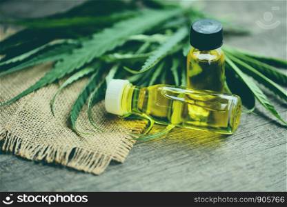 Cannabis oil on bottle products wooden background - CBD oil extract from cannabis leaf Marijuana leaves for Hemp medical healthcare natural selective focus