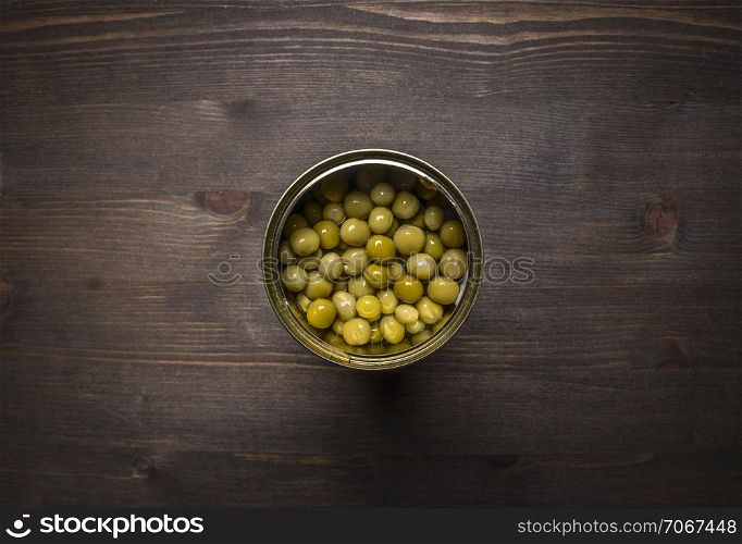 canned peas on wooden rustic background top view close up