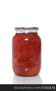 Canned red pepper in a glass jar .. Canned red pepper in a glass jar on a white background.