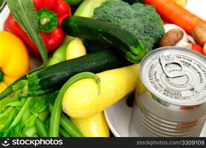 Canned Soup. Can of soup in a bowl surrounded by fresh vegetables