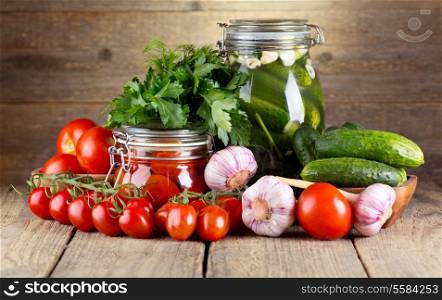 canned tomatoes and cucumbers with fresh vegetables