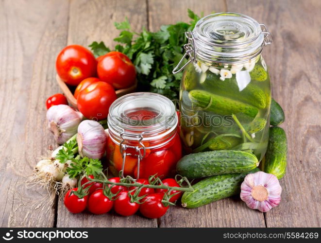 canned tomatoes and cucumbers with fresh vegetables