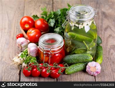 canned tomatoes and cucumbers with fresh vegetables