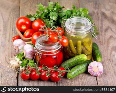 canned tomatoes and pickled cucumbers with fresh vegetables