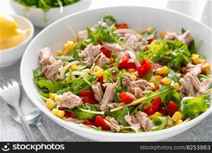 Canned tuna salad with arugula and fresh vegetables