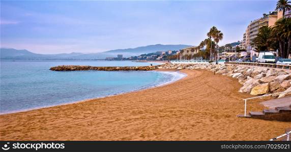 Cannes sand beach and palm waterfront panoramic view, famous tourist destination of French riviera, Alpes Maritimes region of France