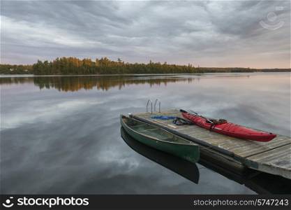 Canoe and Kayak moored at a dock in a lake, Lake of The Woods, Ontario, Canada