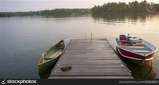 Canoe and motorboat at a dock in Lake of the Woods, Ontario