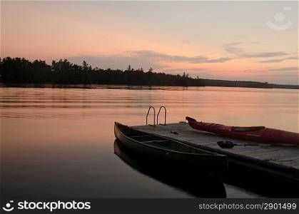 Canoe near a pier in a lake, Lake of the Woods, Ontario, Canada
