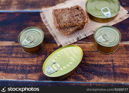 Cans of preserves on an aged wooden background