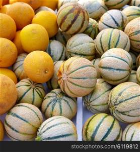 Cantaloupe and yellow melons at the marketplace stacked